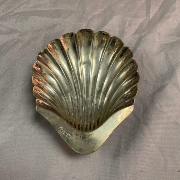 Hallmarked silver pin dish shaped like a shell.