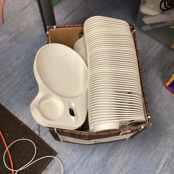 Bulk white plastic party plates for events and gatherings.
