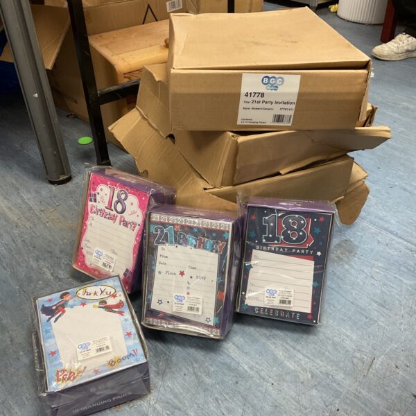 Stack of boxes containing assorted birthday party invitations and thank you cards.