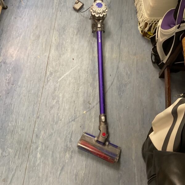 Purple Dyson V6 Animal cordless vacuum cleaner for pet hair removal.