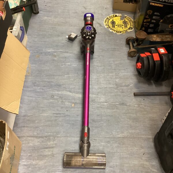 Purple Dyson cordless vacuum cleaner with charger, used condition.