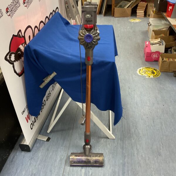 Blue covered Dyson V10 handheld vacuum cleaner for auction.