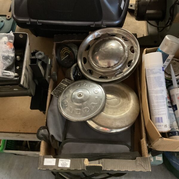 Vintage automotive parts lot with steering wheel hub.