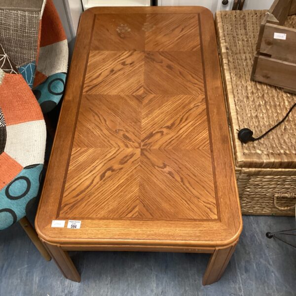 Vintage oak coffee table with inlaid geometric design.
