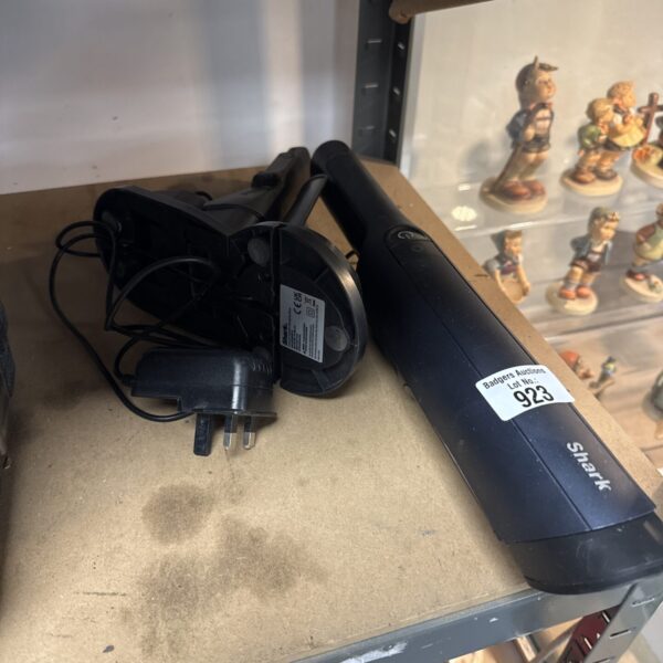 Shark IZ162H handheld vacuum cleaner with charging cradle.