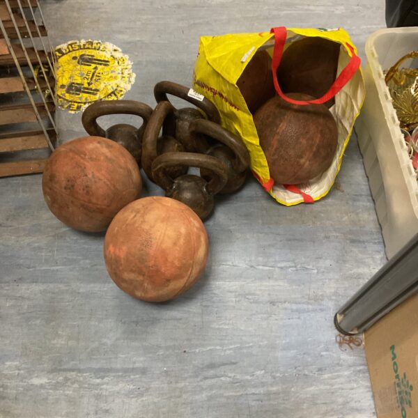 Vintage dumbbells and medicine balls in a lot for collectors.