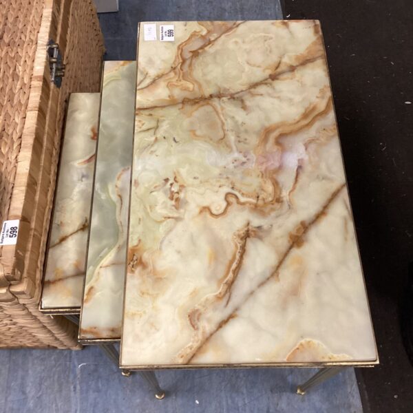 Vintage marble topped brass nesting tables in a home setting.