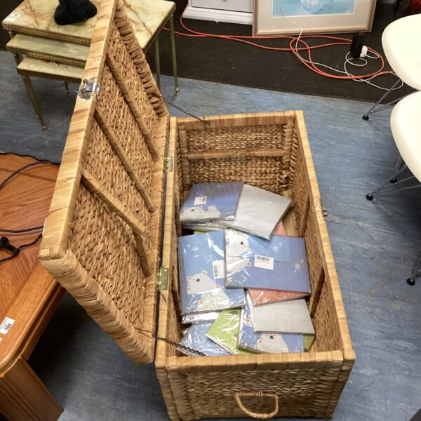 Wicker basket filled with stationery and envelope sets.