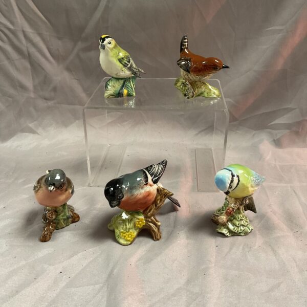 Vintage Beswick bird collection featuring a wren, goldcrest, chaffinch, bullfinch, and blue tit.