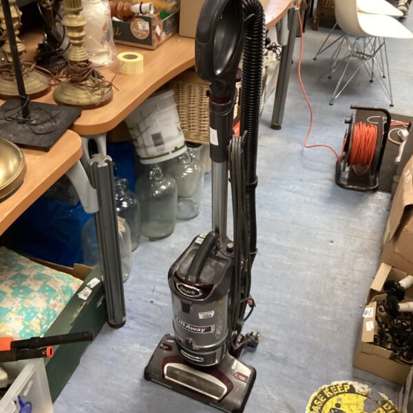 Shark NV652 Lift Away upright vacuum cleaner in a home setting.