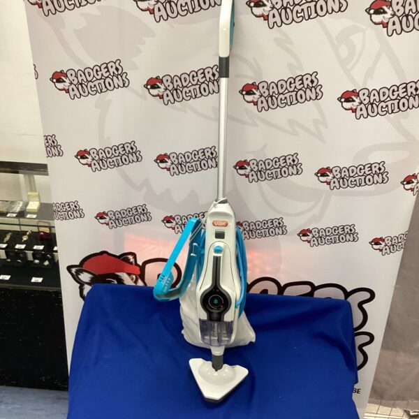 Front view of a Vax steam cleaner with attachments.