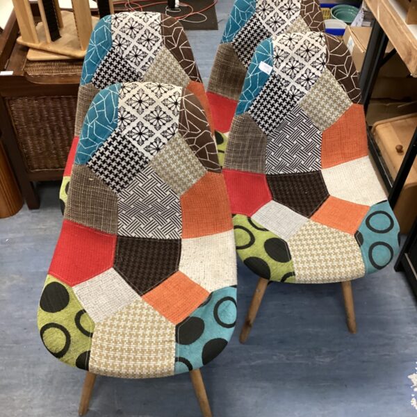 Set of four colourful Westwood-style patchwork chairs.