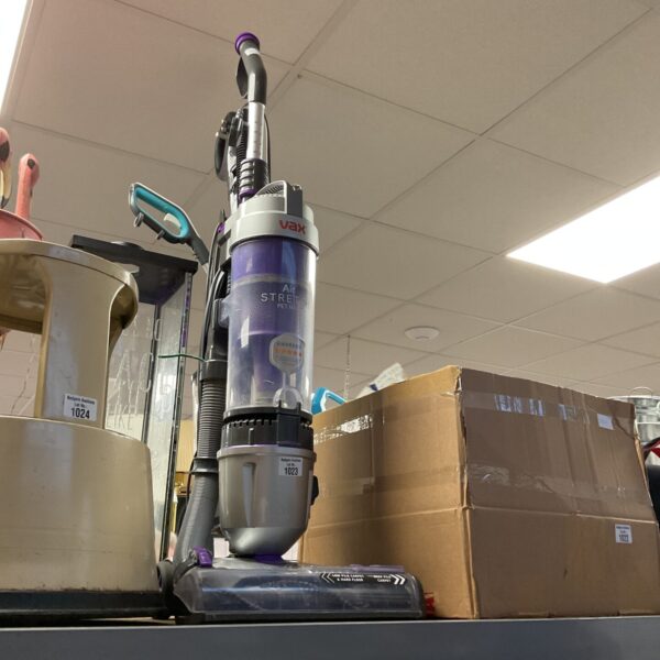 Vax Air Stretch vacuum cleaner in a warehouse setting.