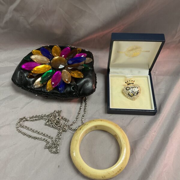 Vintage Butler and Wilson handbag with bone bangle and brooch.