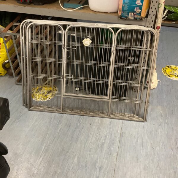 Folding metal dog cage for secure pet transport.