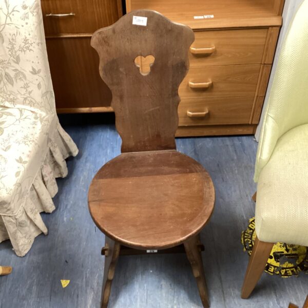 Antique oak spinning chair with sculpted seat and backrest.
