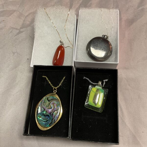 Vibrant orange cabochon pendant on a silver chain necklace.