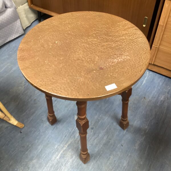 Vintage copper top circular table with tripod legs.