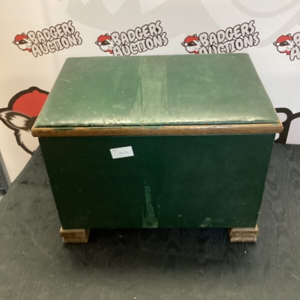 Vintage green leather storage box on display.