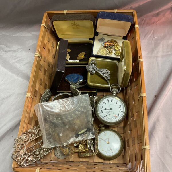 Mixed lot of vintage jewellery and pocket watches on display.