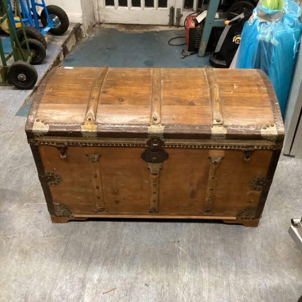 Antique Victorian barrel chest with metal hardware and wooden bands.