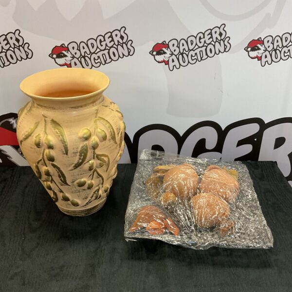 Vintage terracotta vase with gold details and terracotta fruit display.