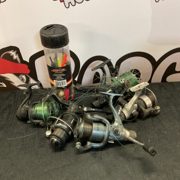 Shimano fishing reel and assorted floats in a tackle lot.