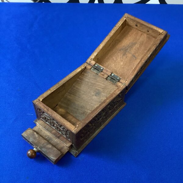 Intricately carved Indian wooden cigarette box with sliding panel.
