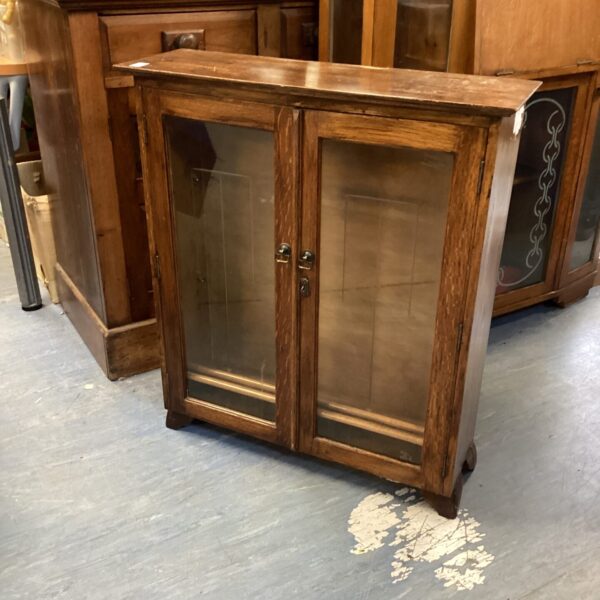 Vintage oak display case with glass front and two shelves.