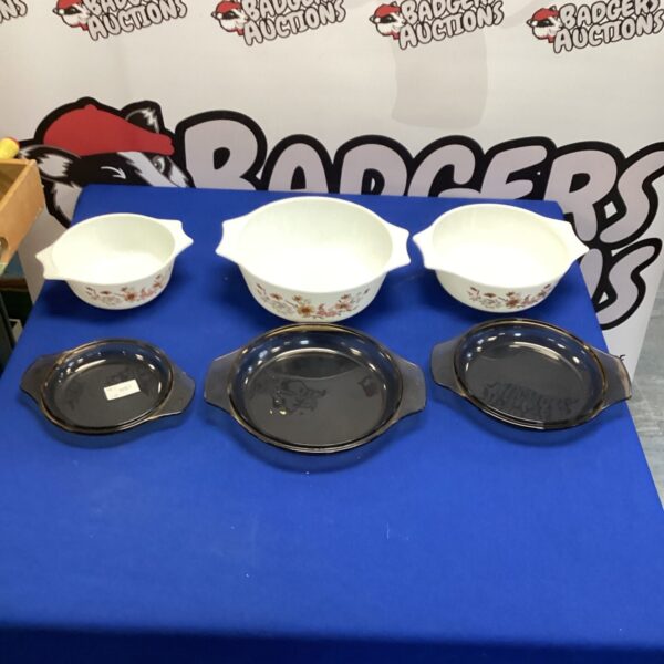 Vintage Pyrex dishes with a floral pattern, ideal for kitchen use.