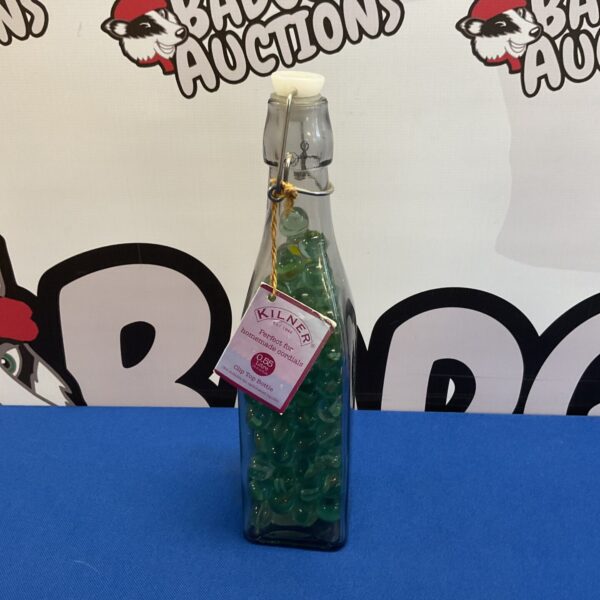 Vintage Kilner bottle filled with colourful glass marbles for display.