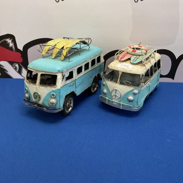 Vintage tin camper van models with surfboards, retro toy.