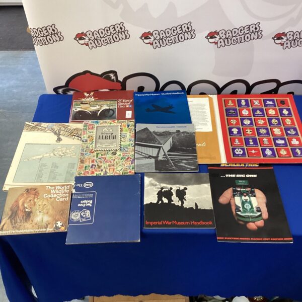 Vintage British regiment stamp and badge collection displayed for sale.