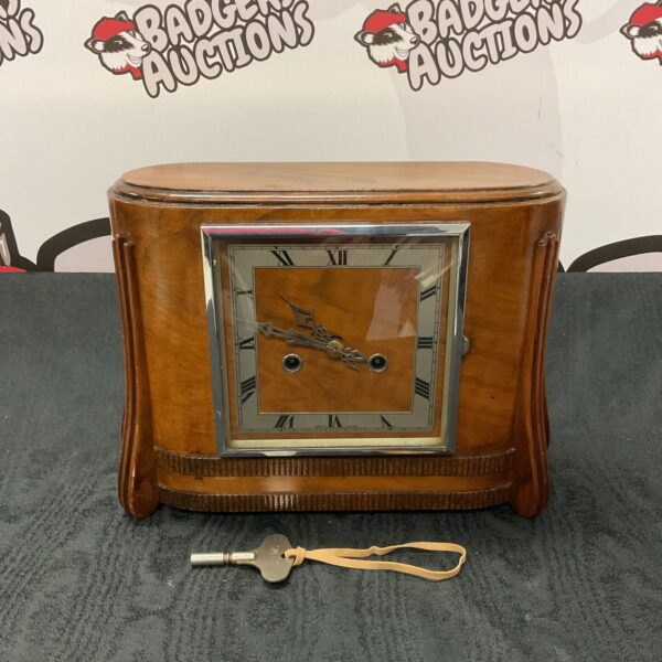 Vintage 1930s mantle clock with wooden case and key.