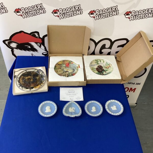 Collection of vintage Wedgwood collectable plates for display.