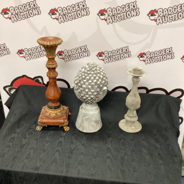 Vintage ornate candle holders and stone garden ornament displayed together.