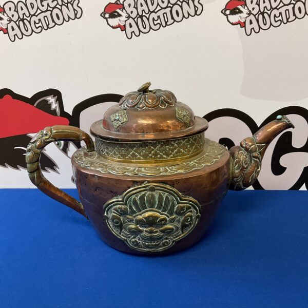 Vintage Tibetan copper teapot with intricate brass detailing.