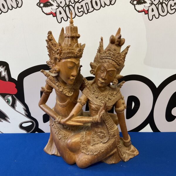 Intricate Balinese wood carving of a deity or figure.