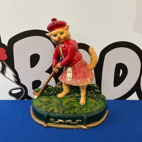 Vintage cast iron golfing cat doorstop on green base.