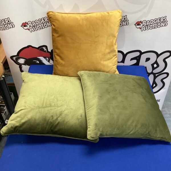 Set of three yellow cushions for home decor.