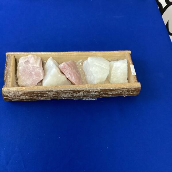 Box of tumbled crystals and gemstones for collection.