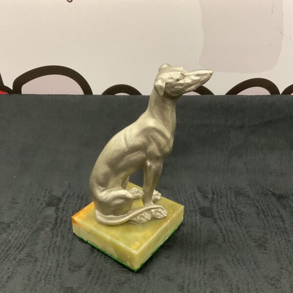 Elegant silvered greyhound sculpture on black onyx base.