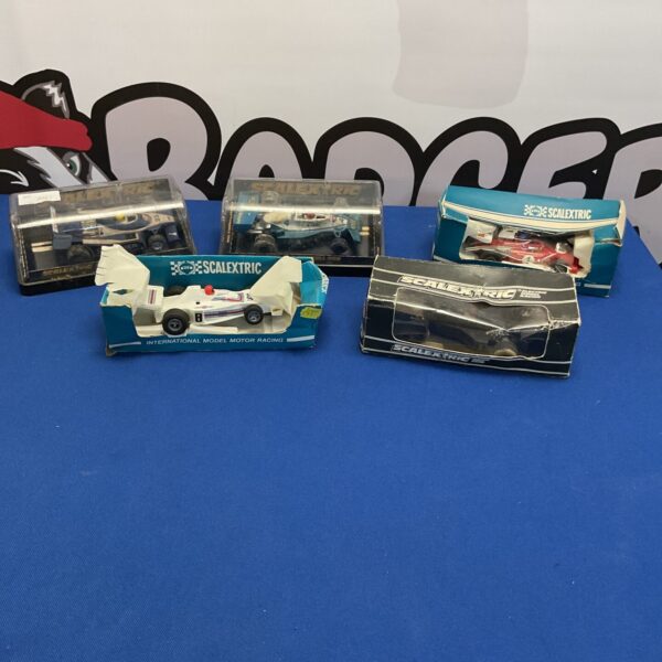 Scalextric diecast model cars in their original boxes, collectible toys.