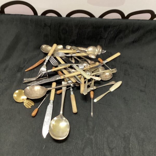 Vintage silverplate cutlery set with forks and spoons.