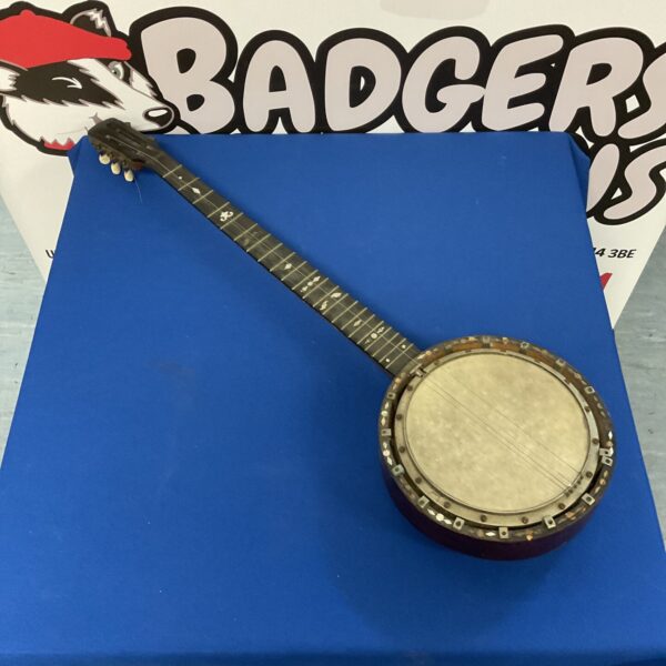 Antique six-string banjo with mother of pearl inlay detailing.