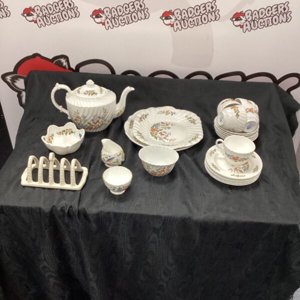 Vintage Aynsley tea set with floral pattern on display.