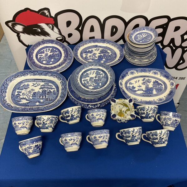 A collection of blue and white willow pattern china from Churchill and Staffordshire.