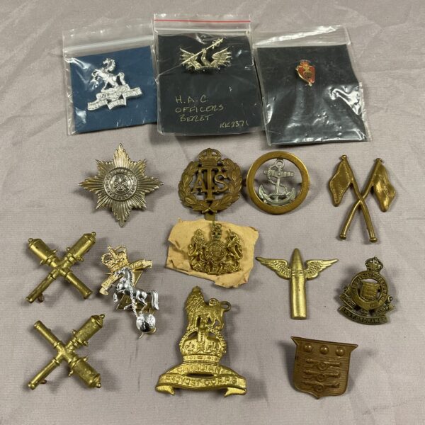 Collection of British military cap and collar badges from WWII.