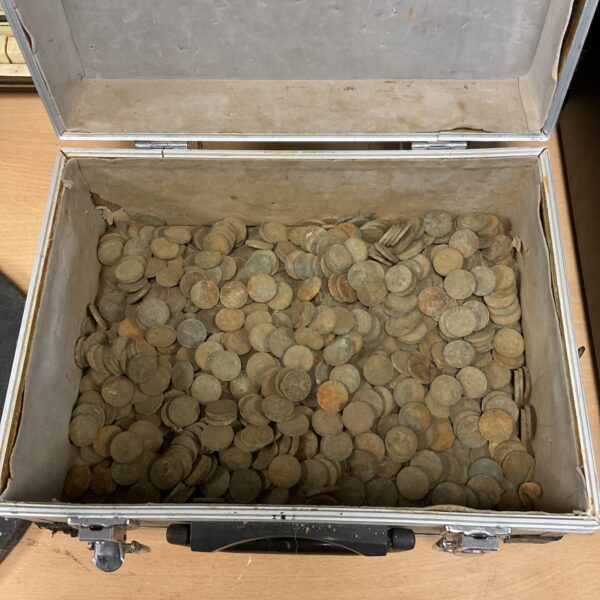 Large collection of brass threepenny bits in a metal case.