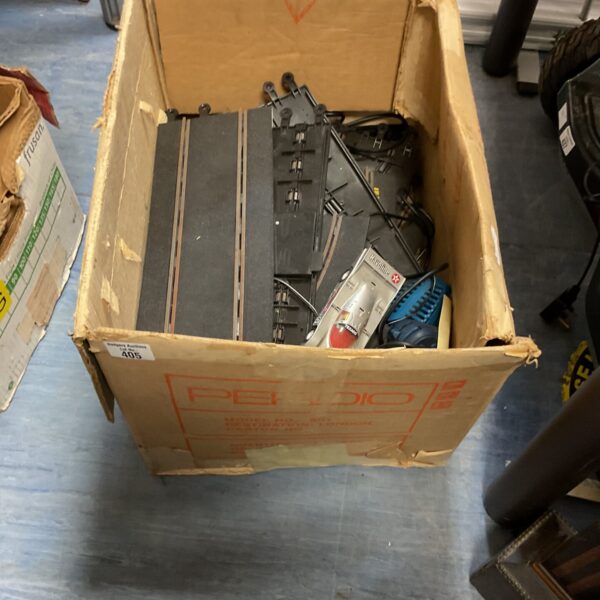 Box of vintage Hornby race car sets with cars and track pieces.